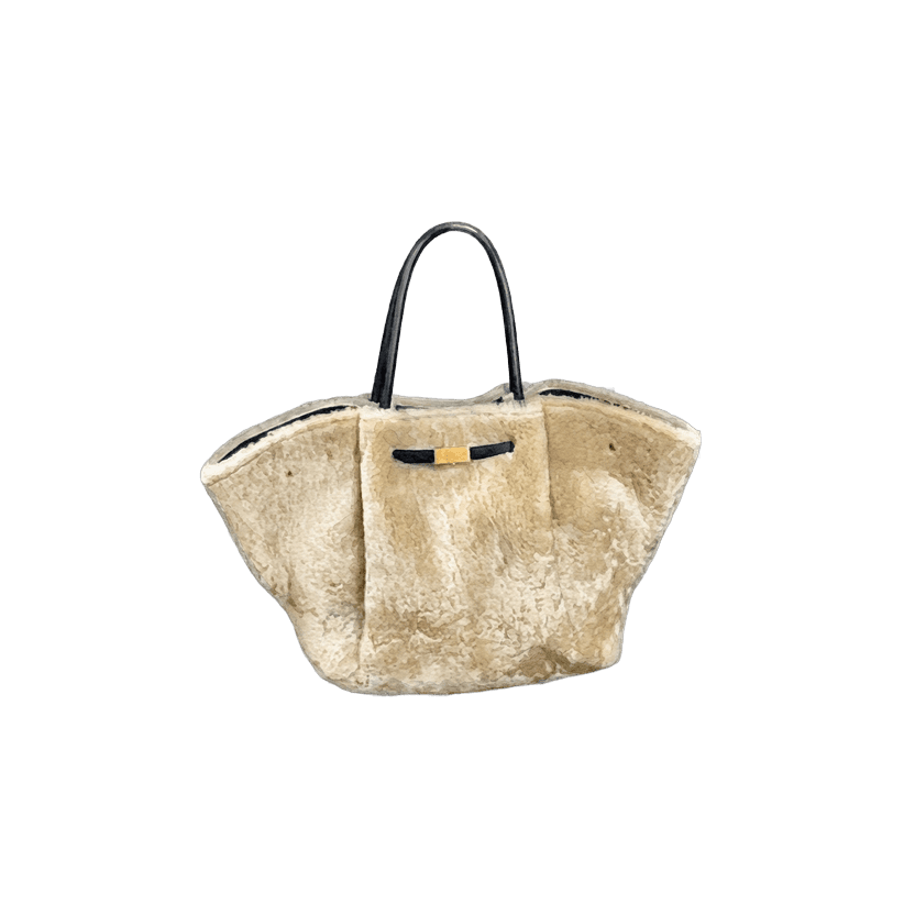 Cream shearling tote bag with black leather handles