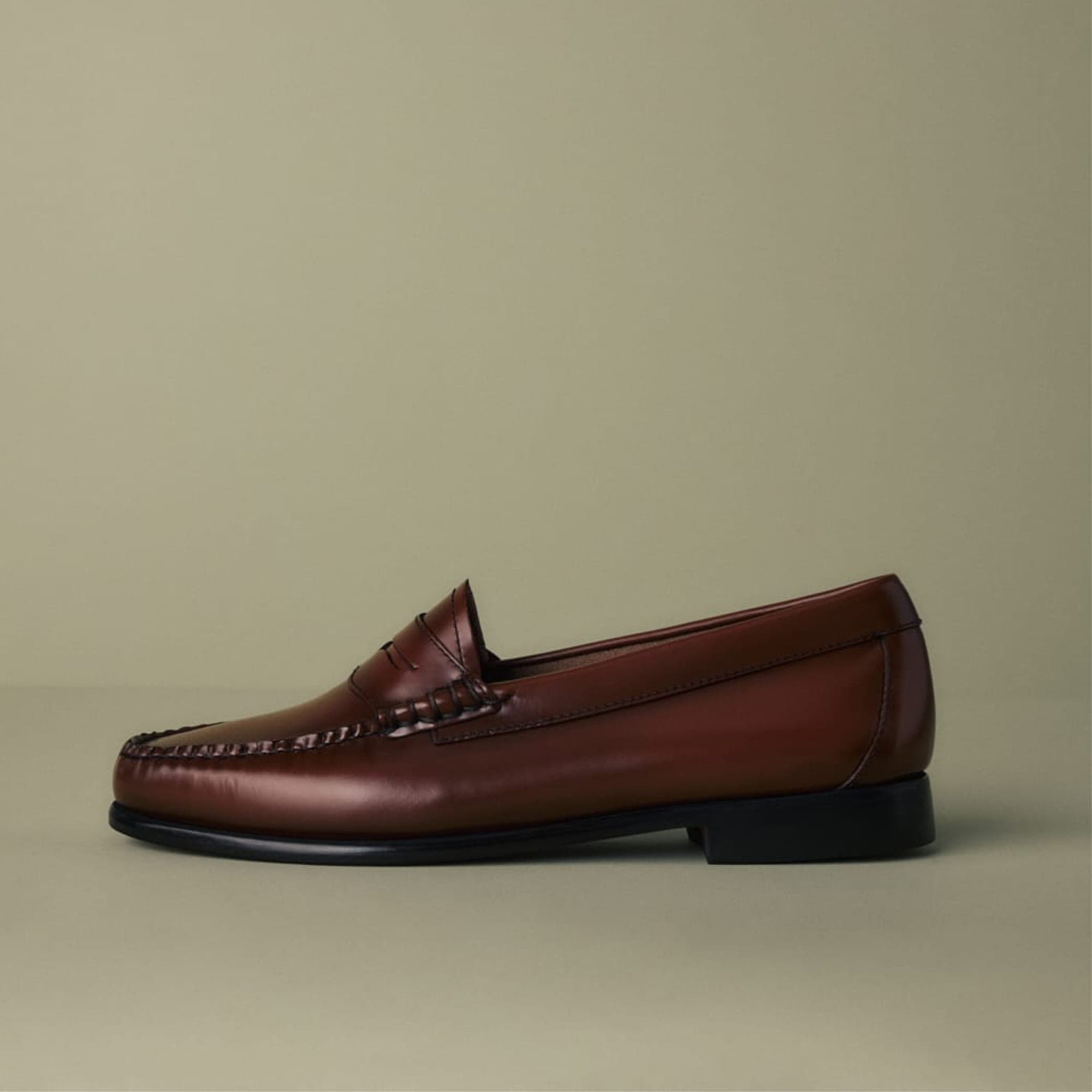 Wine oxblood G.H. Bass Whitney Weejuns penny loafers worn by a model.