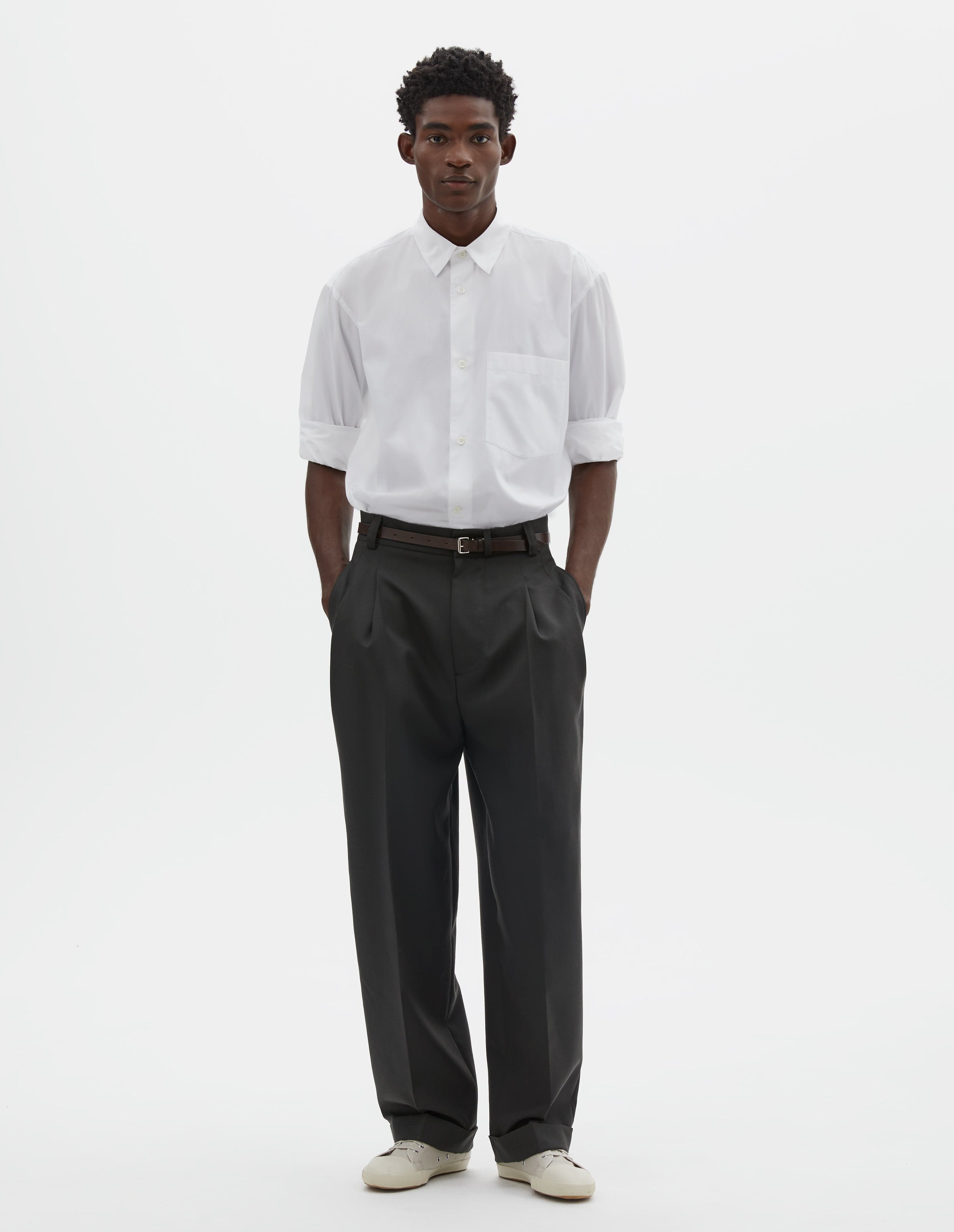 Margaret Howell slim wool trousers styled with a dark knit and flats.