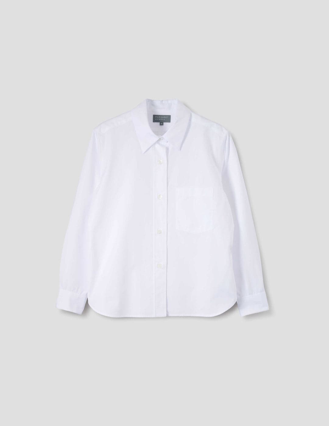Margaret Howell white poplin shirt photographed on a model.